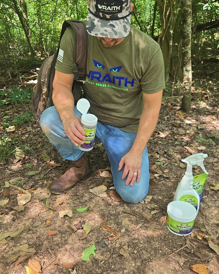 In the field: a hunter kneeling on the forest floor with the 16 oz shaker, spray bottle and bulk canister beside him