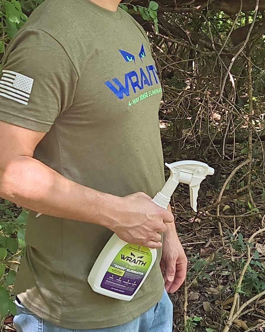 In the field: the WRAITH 23 oz spray bottle carried at a hunter's side in green timber